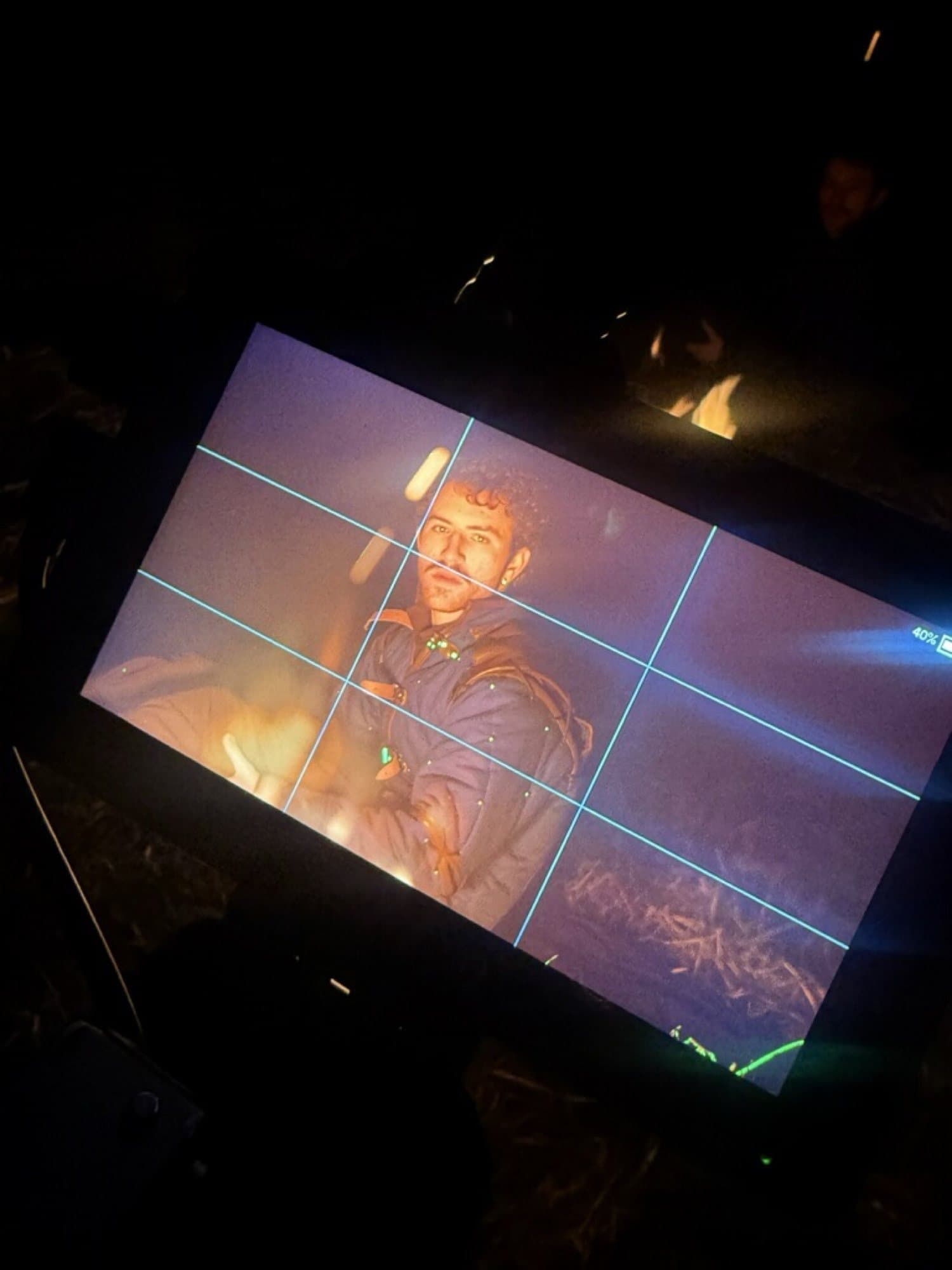 AJ DeAugustine on a camera monitor by firelight